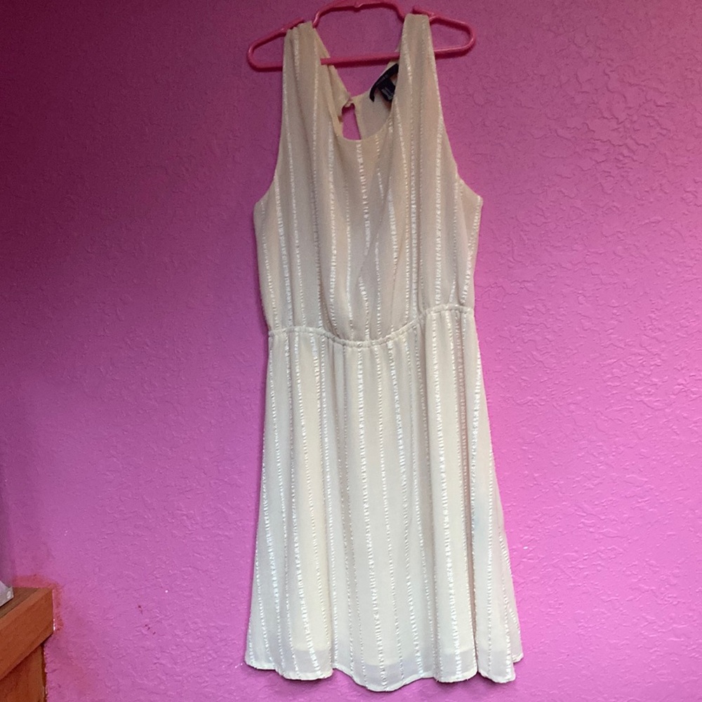 Size S cream colored dress with an opening in the back. Brand forever 21.